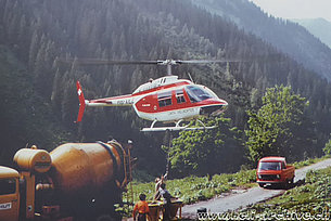 Glarus alps, late 1970s - The Agusta-Bell 206B Jet Ranger II HB-XEZ in service with Linth Helikopter trasports fresh concrete (fam. Kolesnik)